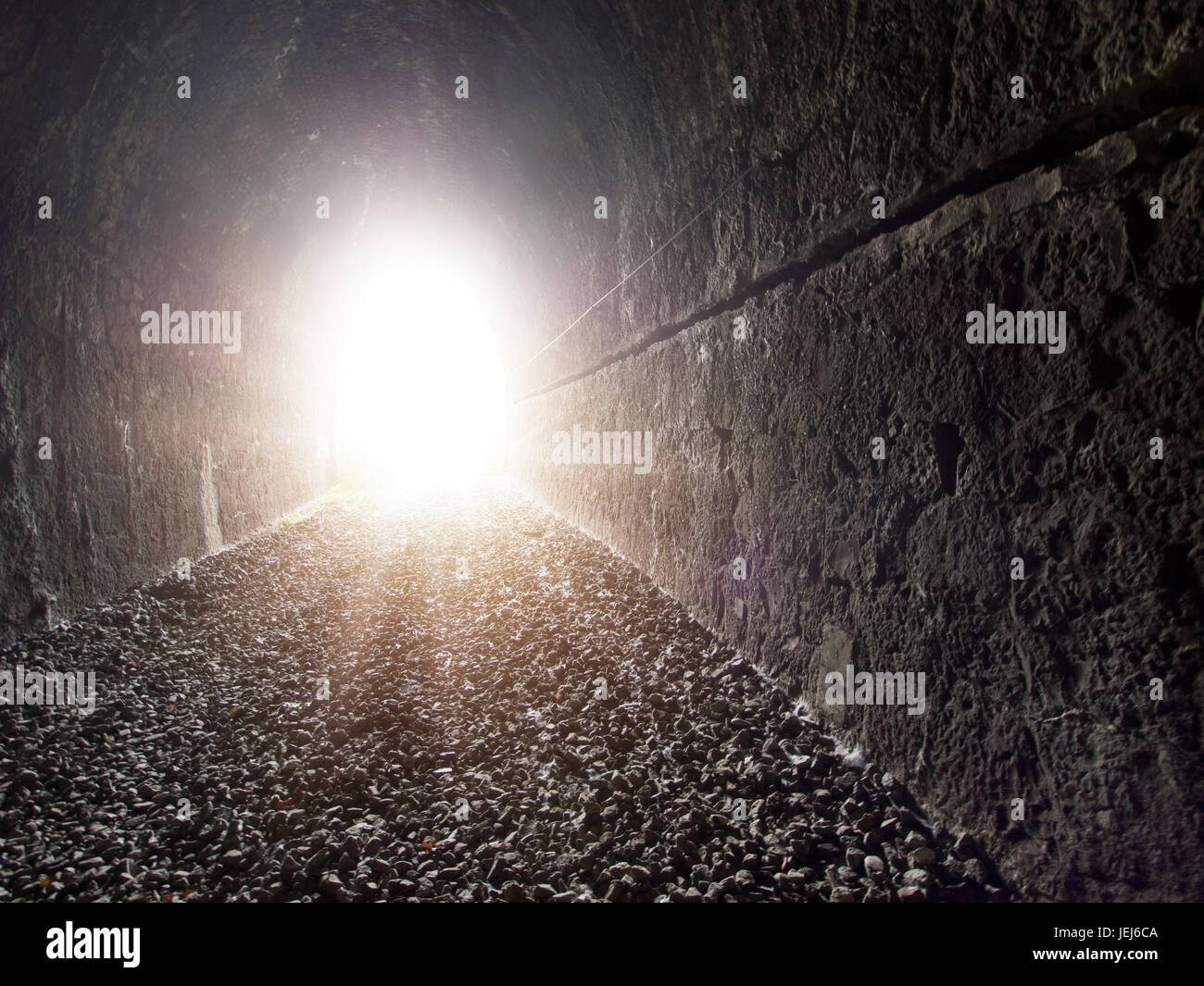 Light at the end of the tunnel. Old, disused railway tunnel. Stock Photo