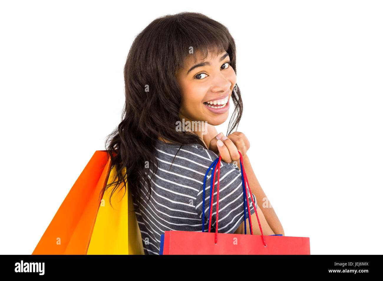 Rear view of a casual woman holding shopping bags Stock Photo - Alamy