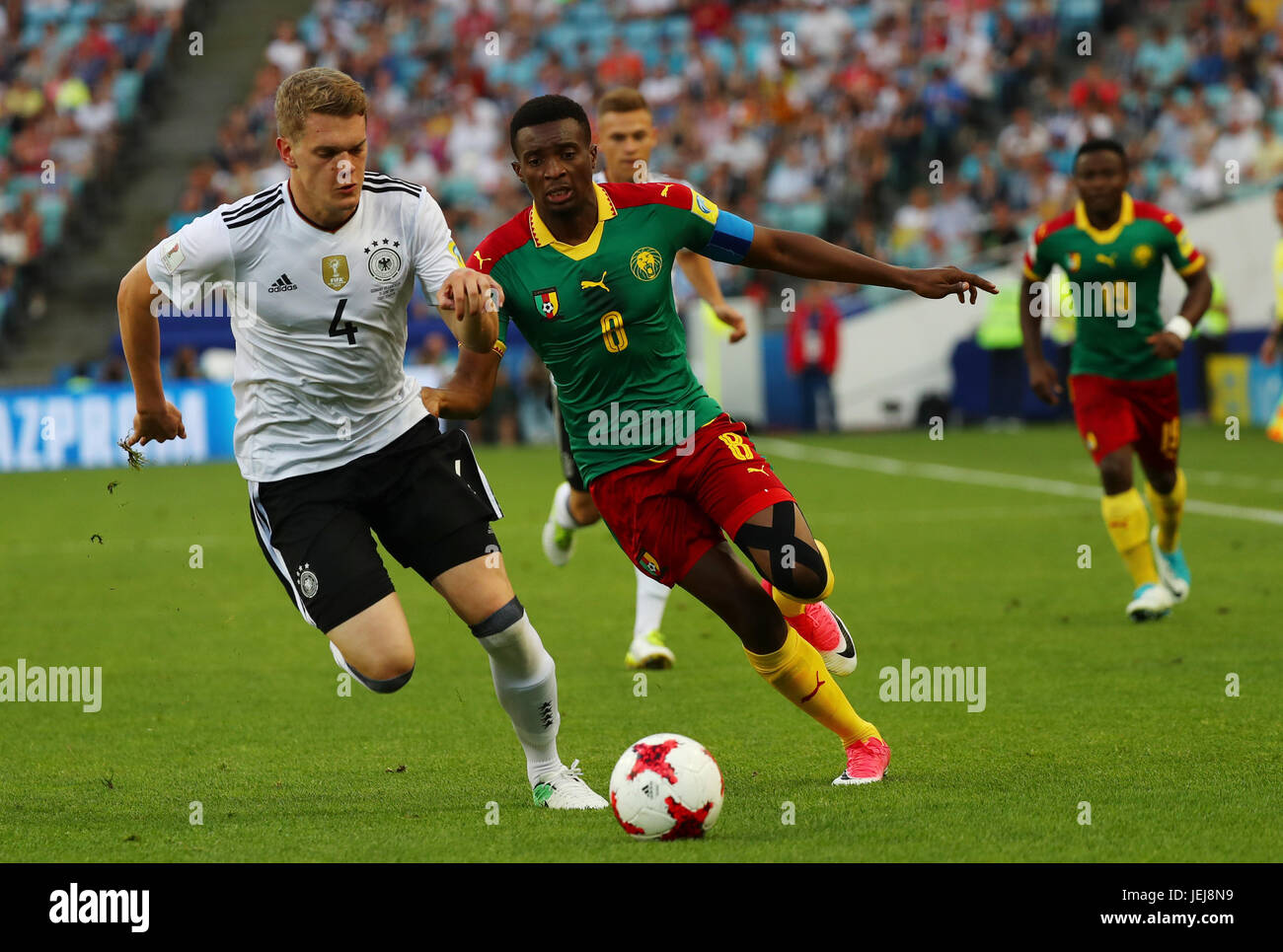 Sochi, Russia. 25th June, 2017. Germany's Matthias Ginter and Cameroon's Benjamin Moukandjo vie for the ball during the Confederations Cup preliminaries group B match between Germany and Cameroon in the Fisht Staduim in Sochi, Russia, 25 June 2017. Photo: Christian Charisius/dpa/Alamy Live News Stock Photo