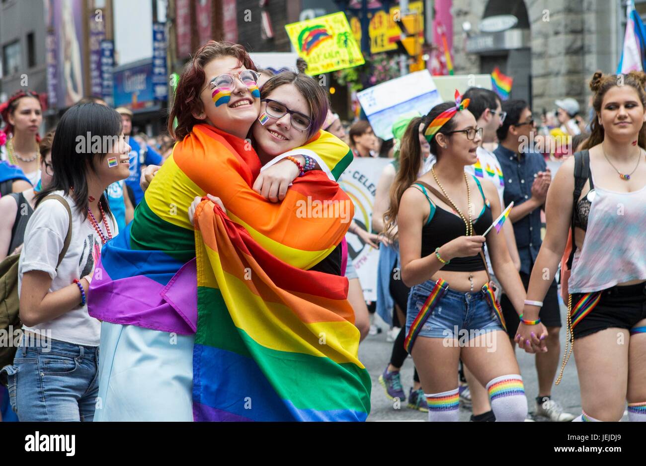 Toronto, Canada. 25th June, 2017. Two women hug during the 2017 Pride Parade in Toronto, Canada, June 25, 2017. Credit: Zou Zheng/Xinhua/Alamy Live News Stock Photo