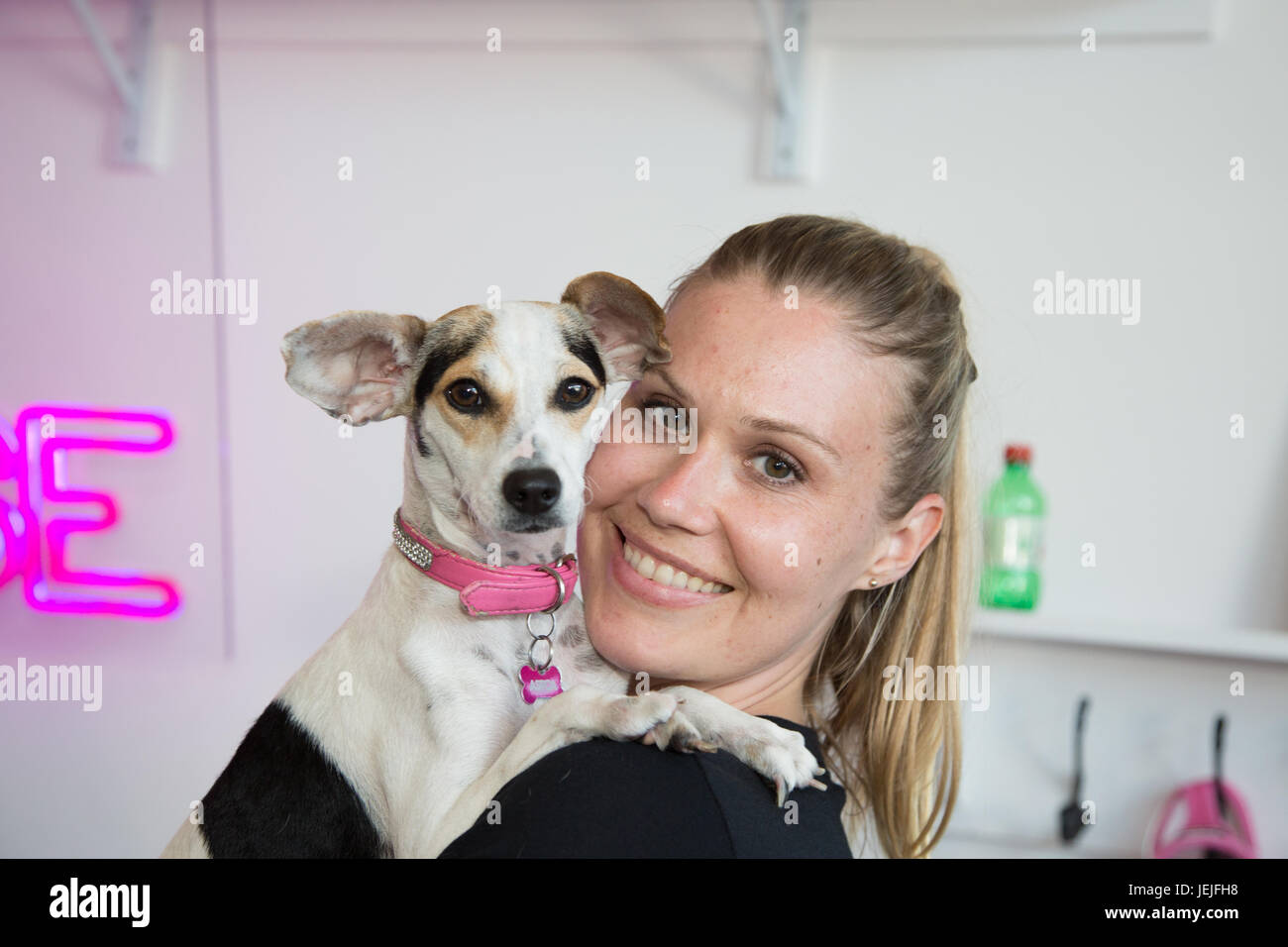 Los Angeles, California, USA. 25th June, 2017. Ryel Toby, who works at Vanderpump Dogs, holds a dog named 'Jewel', who is up for adoption during World Dog Day 2017 in Los Angeles, California on June 25th, 2017.  Vanderpump Dogs is a store and organization that specializes in dogs and is owned by  owned by celebrity/entrepreneur Lisa Vanderpump. Credit: Sheri Determan/Alamy Live News Stock Photo