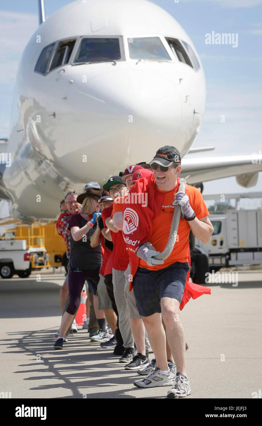 Vancouver, Canada. 25th June, 2017. People participate in the Plane Pull fundraising campaign in Vancouver, Canada, June 25, 2017. Participants competed to pull a Boeing 757 jet weighing over 58,000 kg across the tarmac at Vancouver International Airport on Sunday, to raise money for kids, families and seniors in the Lower Mainland region around Vancouver. Credit: Liang Sen/Xinhua/Alamy Live News Stock Photo