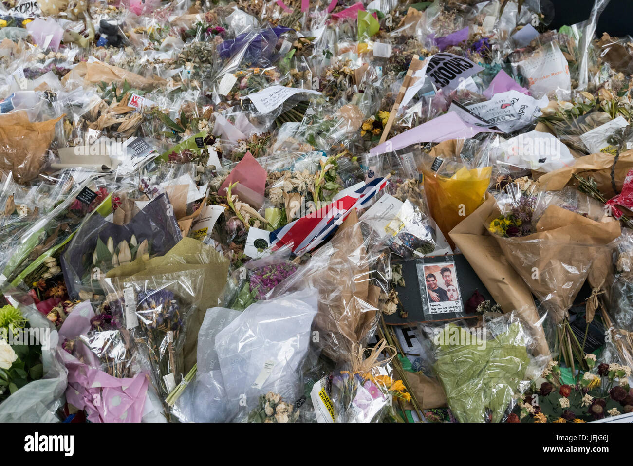 London, UK. 24th June, 2017. London, UK. 24th September 2017. A photograph and tributes in the huge pile of flowers remembering those killed in the London Bridge attack at the south end of London Bridge. Most of the flowers have now faded. Peter Marshall ImagesLive Credit: Peter Marshall/ImagesLive/ZUMA Wire/Alamy Live News Stock Photo