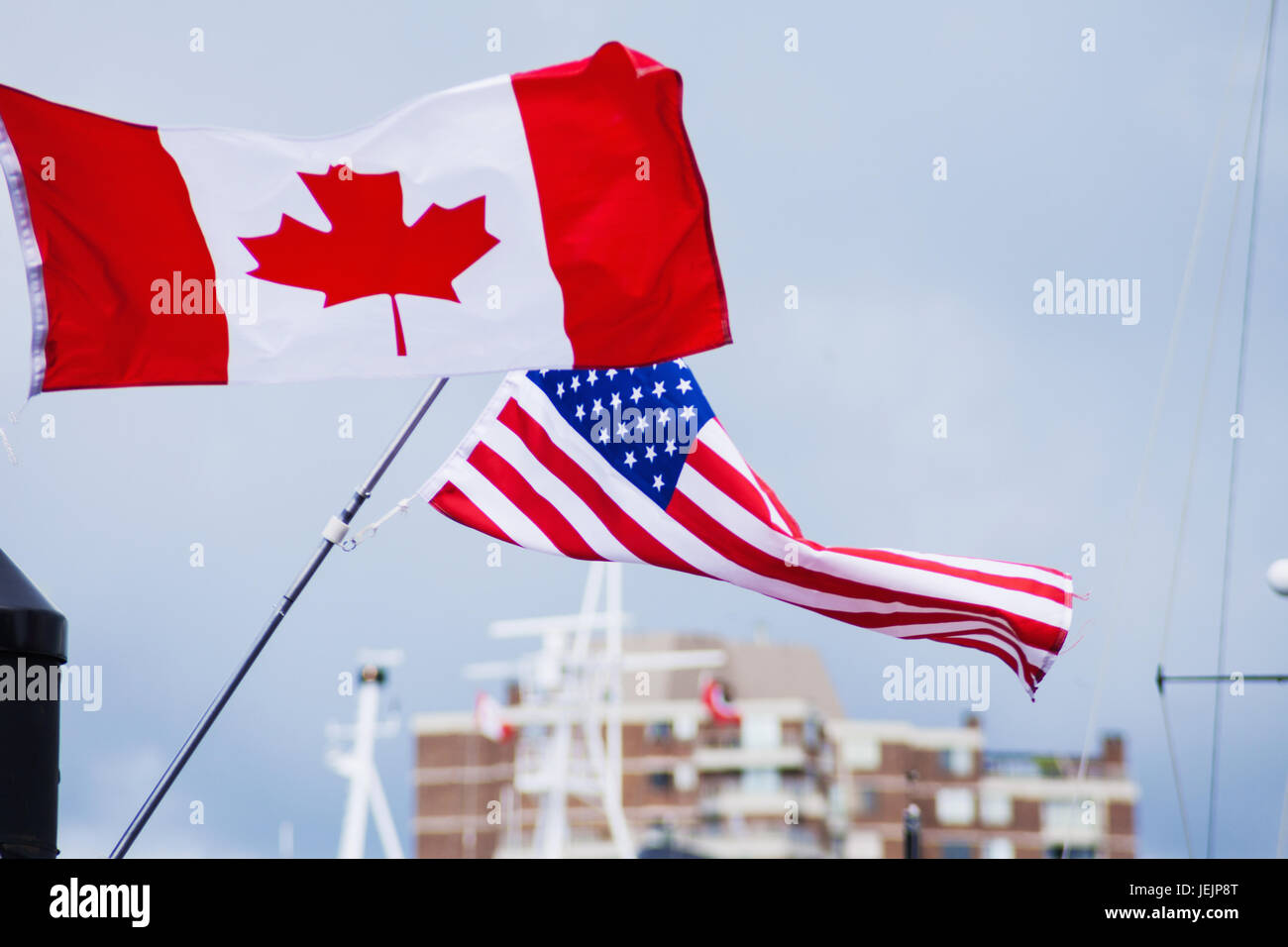 Flags of Canada Canadian and USA American blowing in wind Stock Photo
