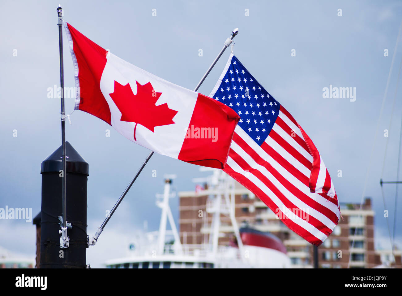 Flags of Canada Canadian and USA American blowing in wind Stock Photo