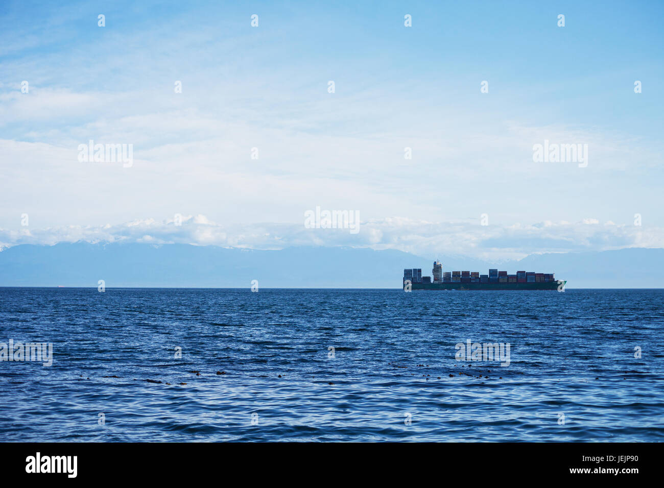 Cargo ship carrying containers in Juan de Fuca Strait.  Victoria BC Canada Stock Photo