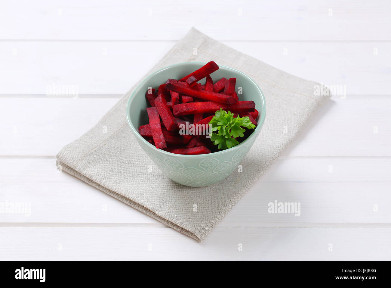 bowl of beetroot strips on beige place mat Stock Photo