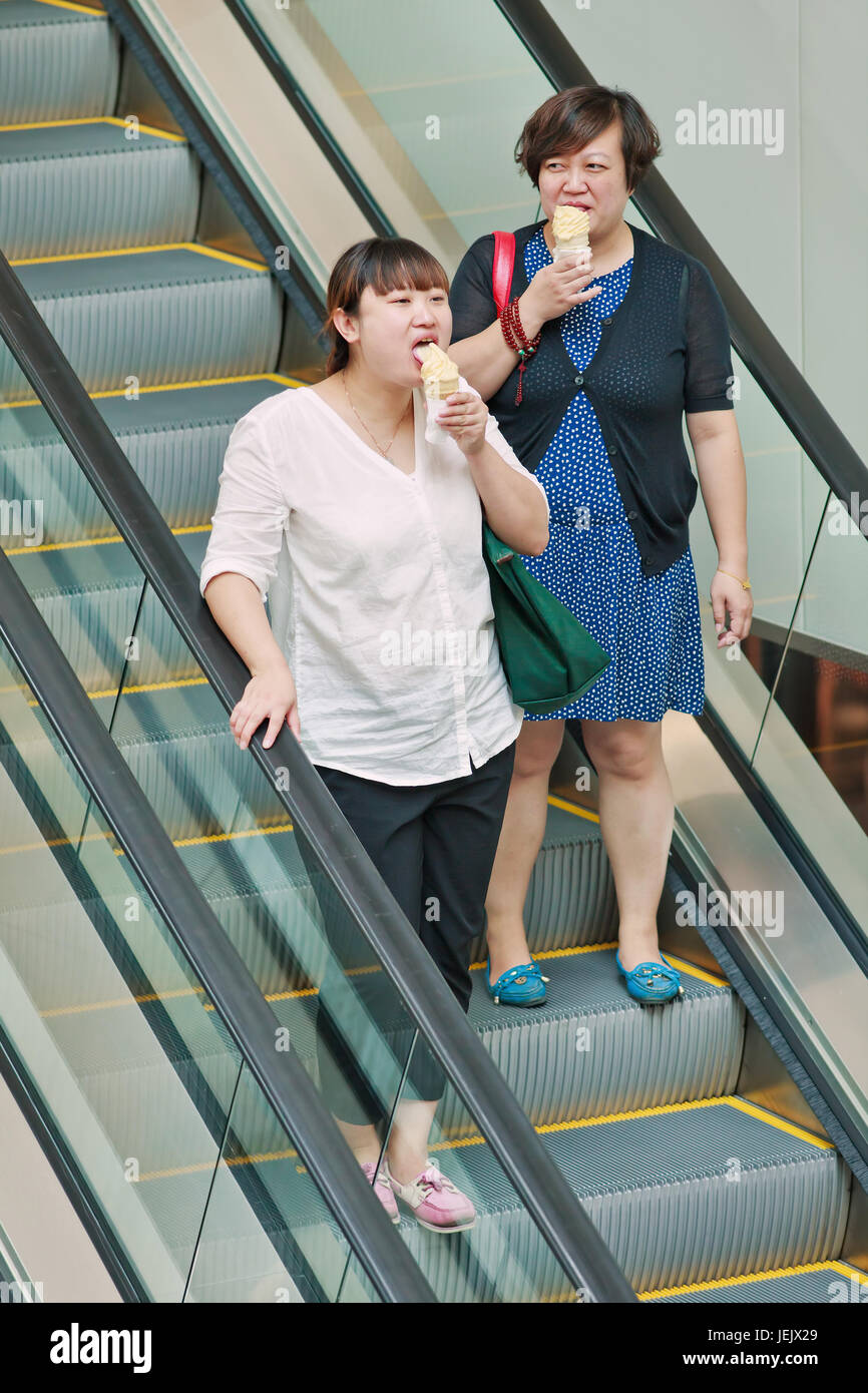 Woman eating ice cream fat hires stock photography and images Alamy