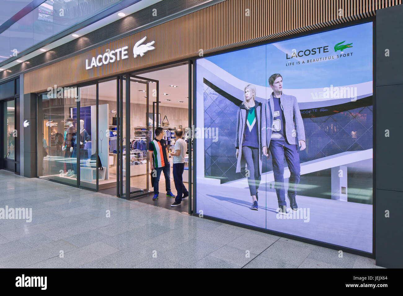 Porque Bombero Lírico BEIJING-AUG. 21, 2015. Lacoste outlet. Lacoste is a French clothing company  founded in 1933, sells high-end clothing and footwear Stock Photo - Alamy