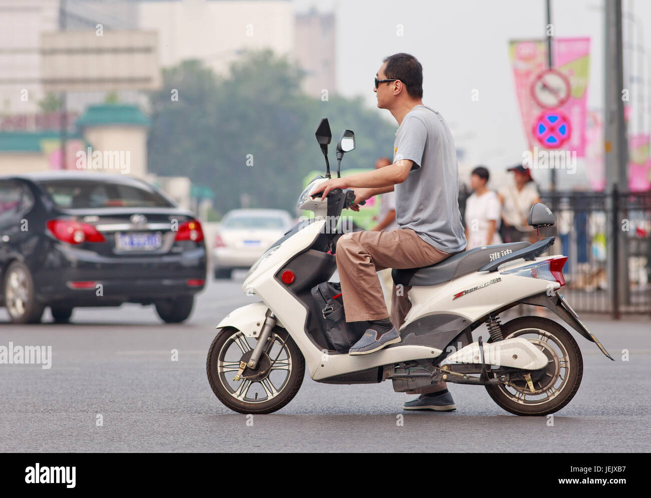 BEIJING-JULY 27, 2015. Man on new e-bike. In a decade, e-bikes in China ...