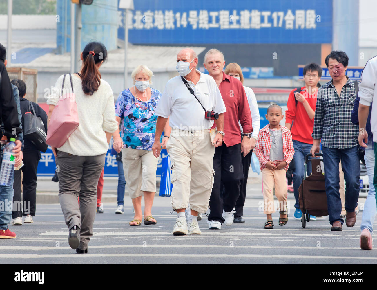 BEIJING- OCT. 6. Foreign tourists in Beijing city center take precautions against severe air pollution. Stock Photo