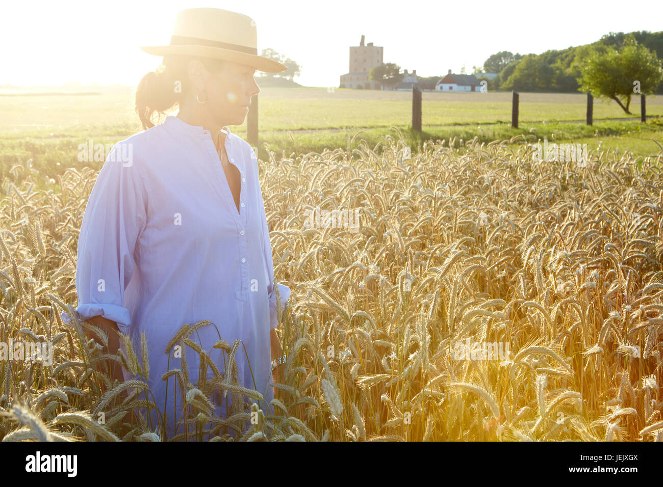 Mature woman standing on wheat field Stock Photo - Alamy