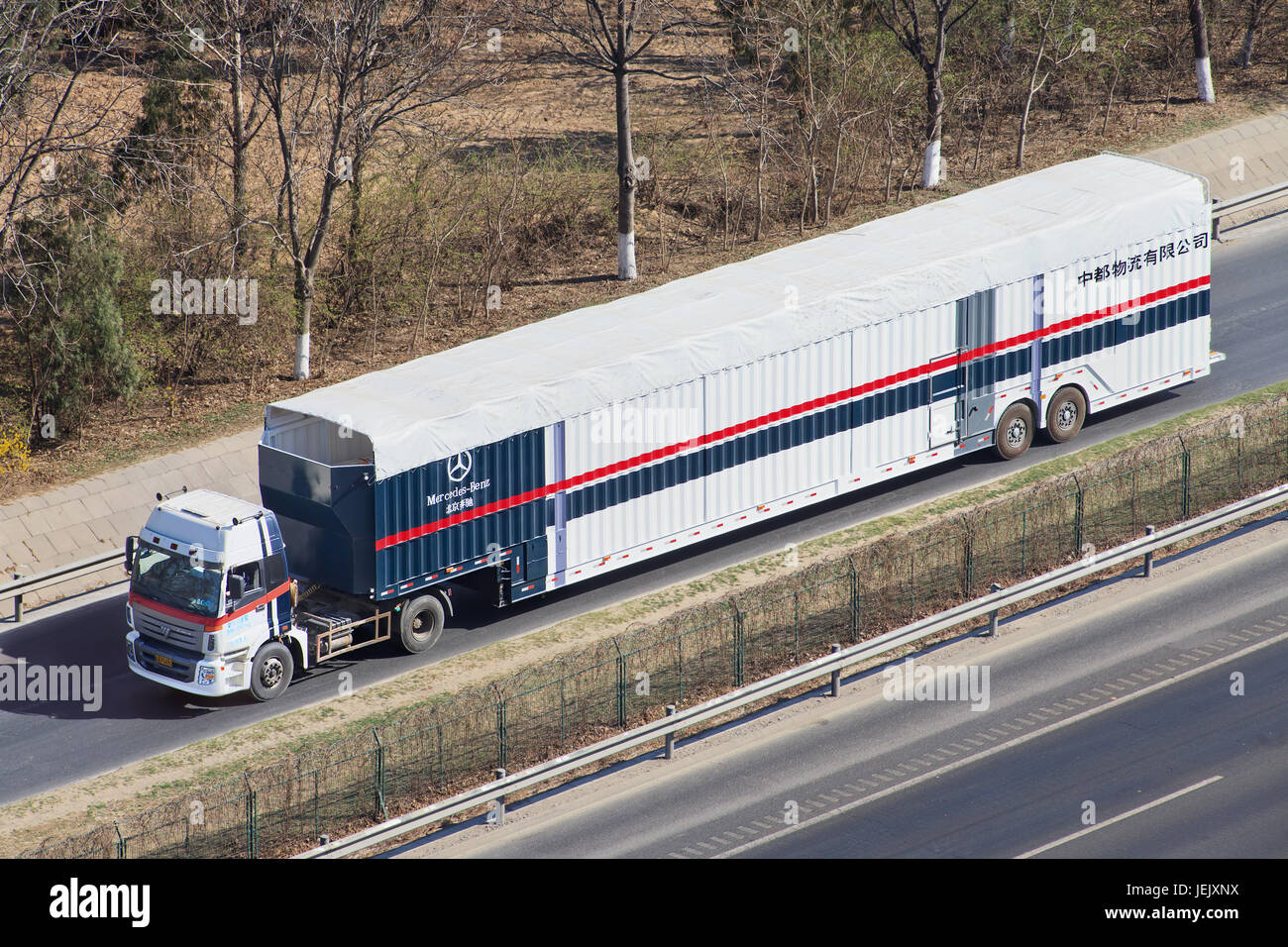 BEIJING-MARCH 25, 2016. Oversized Mercedes Benz car carrier. These illegal car trailers have lengths up to 40m, prohibited enter urban areas. Stock Photo