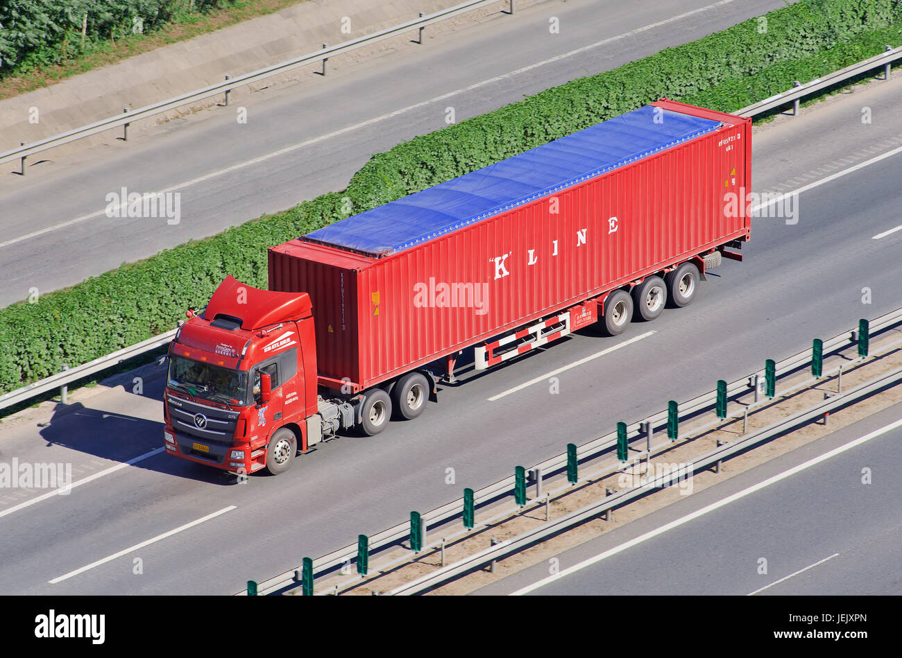 BEIJING-JUNE 30, 2015. Chinese truck with K Line container. Kawasaki Kisen Kaisha (K Line) is one of the largest Japanese transportation companies. Stock Photo