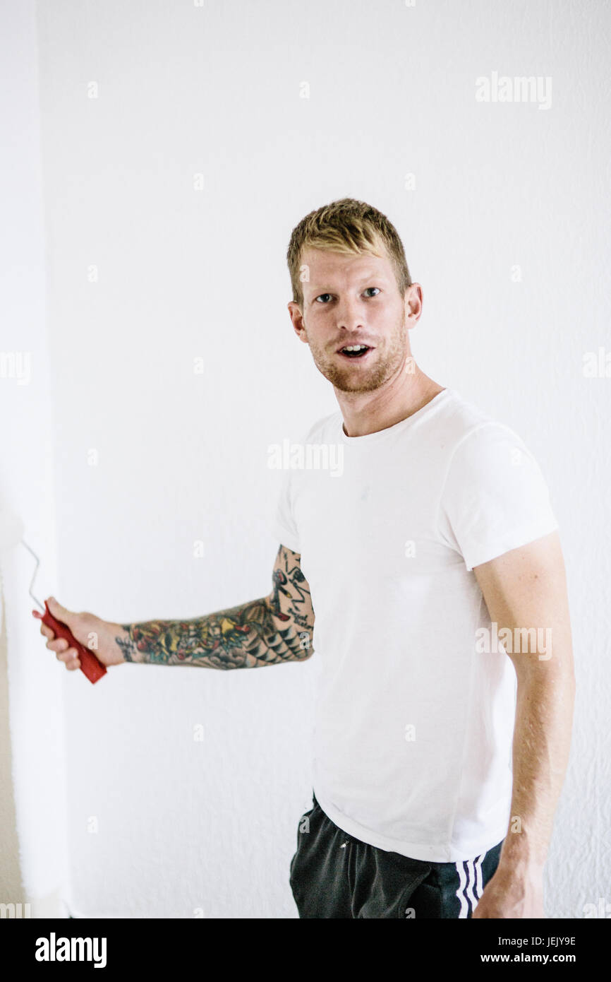 Young man paints wall hi-res stock photography and images - Alamy