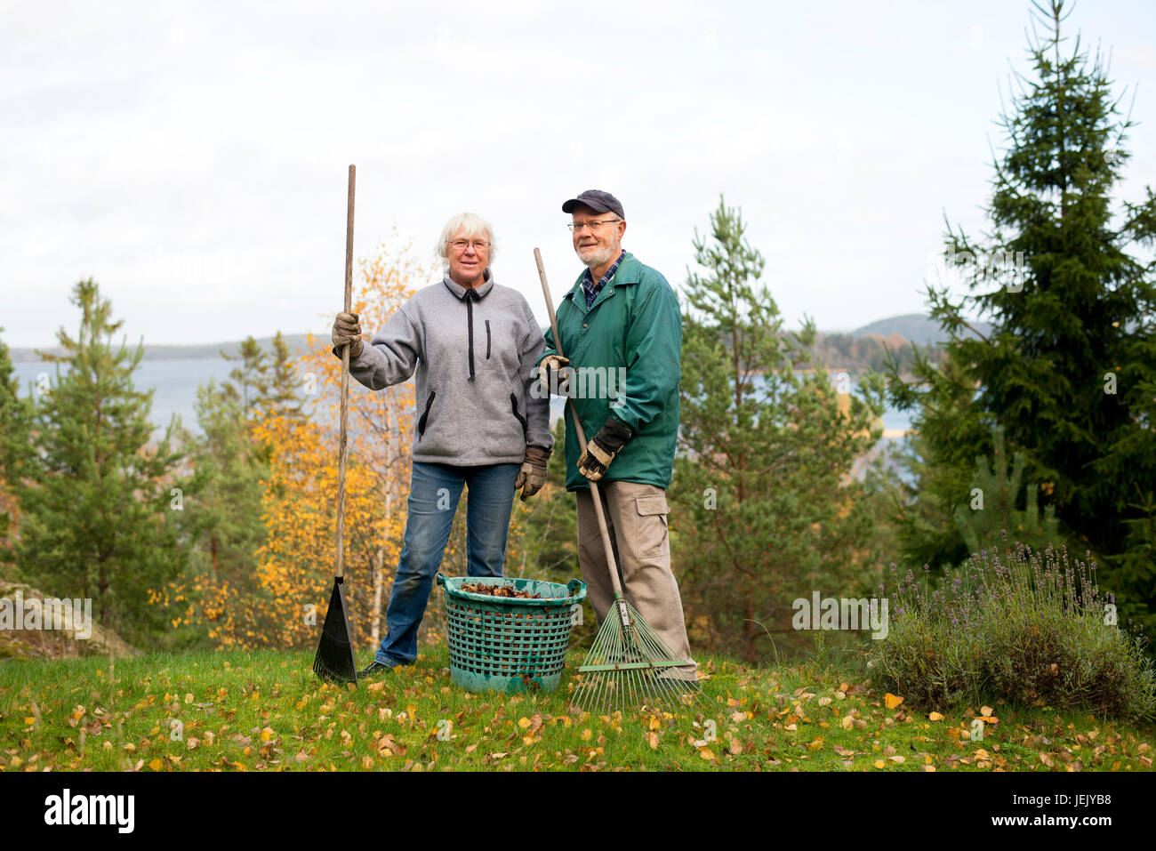 Senior woman standing rake hi-res stock photography and images - Alamy