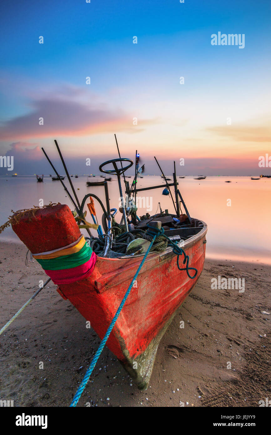 Small fishing boat used as a vehicle for finding fish in the sea.at sunset Stock Photo