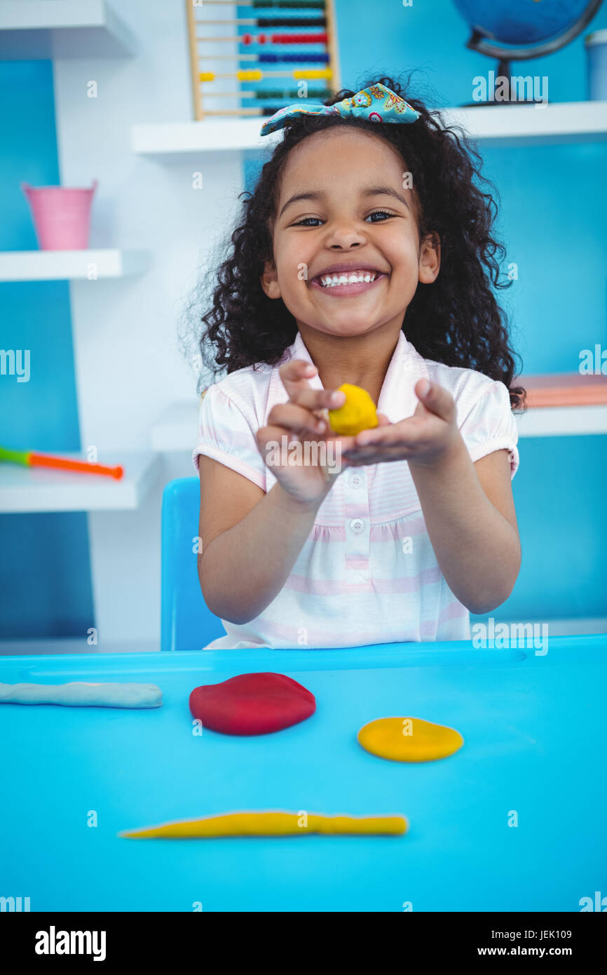 Cute girl using modeling clay Stock Photo Alamy