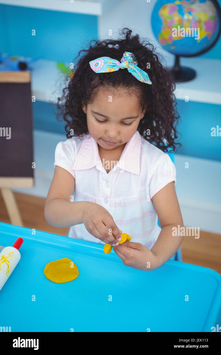 Cute girl using modeling clay Stock Photo Alamy