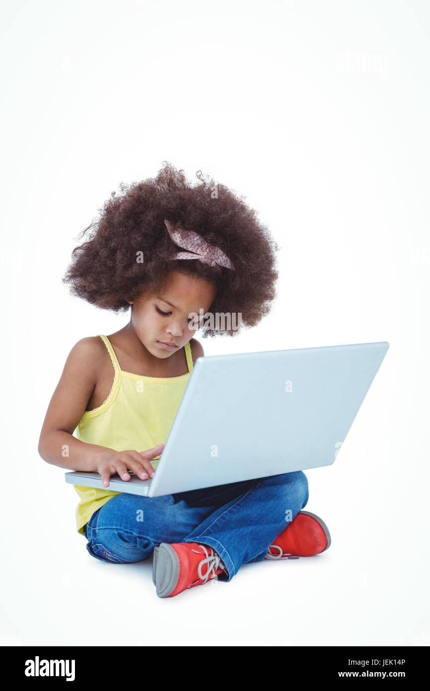 Cute girl sitting on floor using laptop Stock Photo - Alamy
