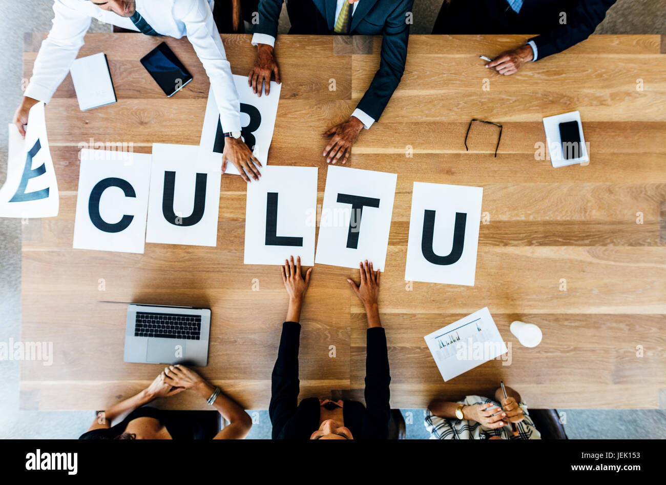 Top view of business group placing the word sign Culture on table. business people meeting and discussing over work culture in office. Stock Photo