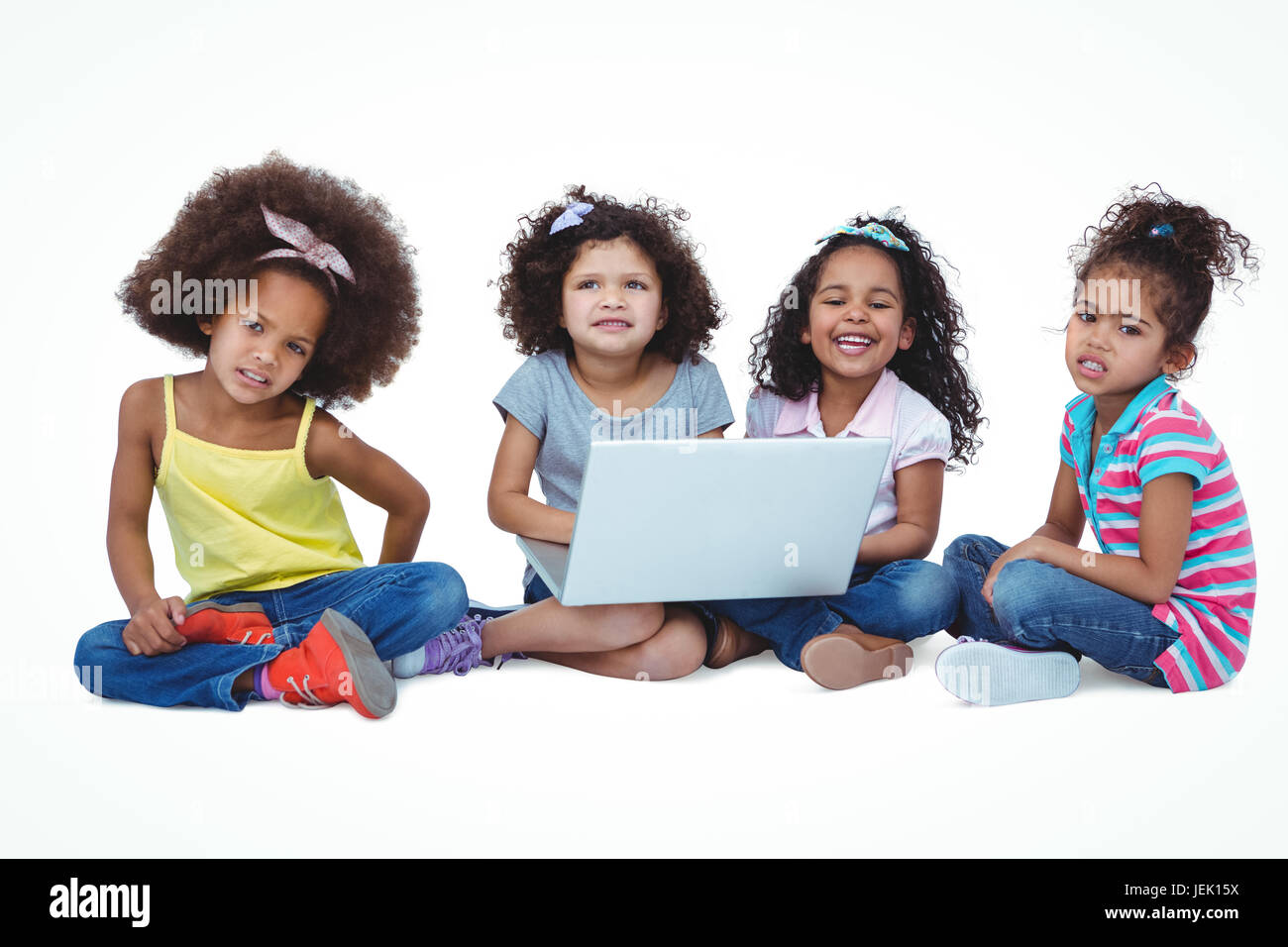 Cute girls sitting on the floor using laptop Stock Photo - Alamy
