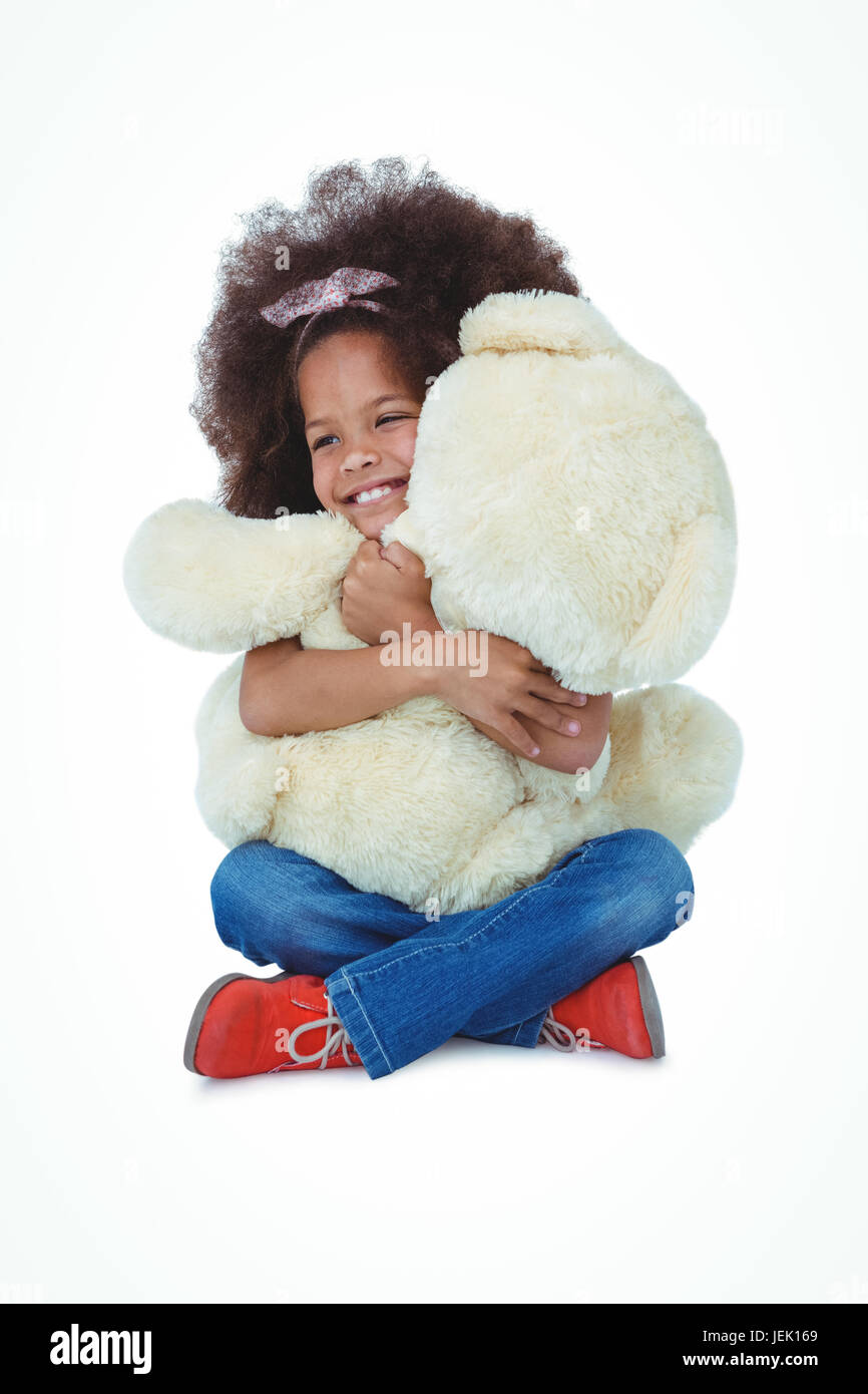 Cute girl sitting on the floor hugging teddy bear Stock Photo - Alamy