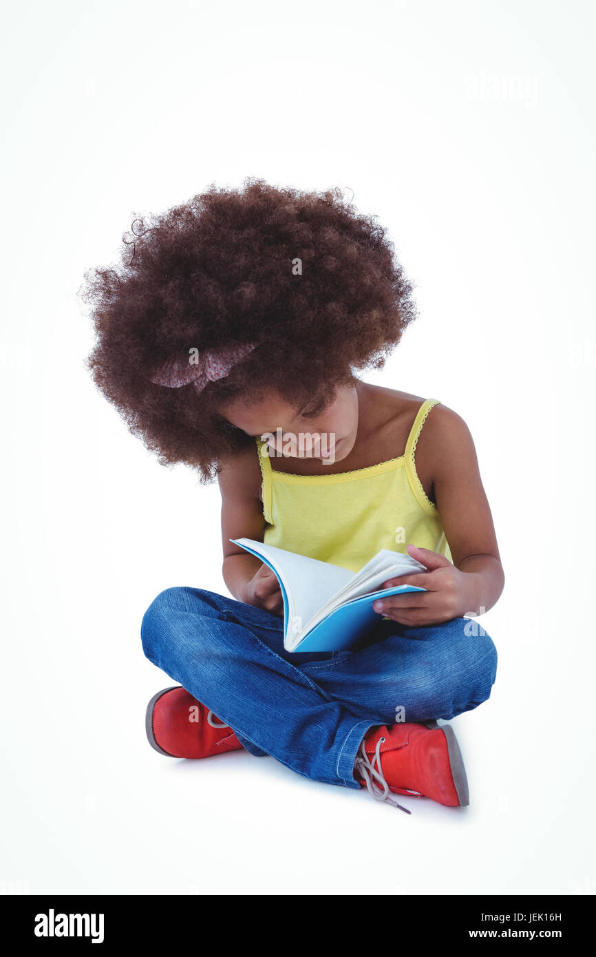 Cute girl sitting on the floor holding book Stock Photo - Alamy
