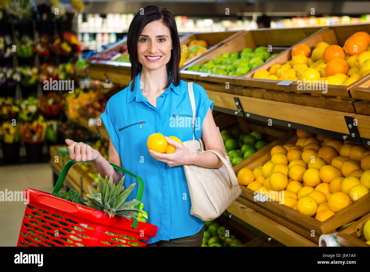 Portrait of a smiling woman with a basket Stock Photo - Alamy