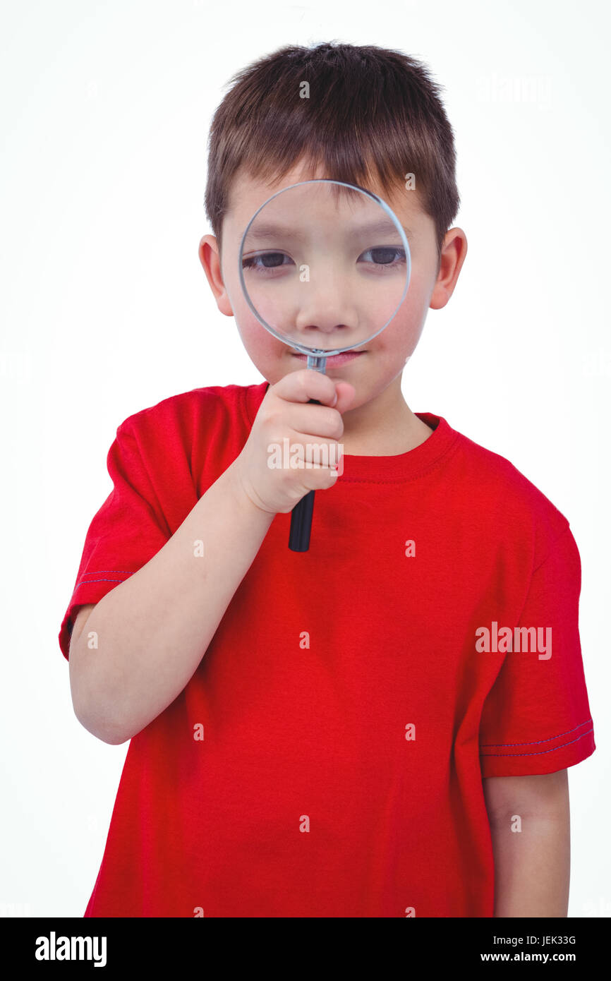 Standing boy using magnifying glass Stock Photo - Alamy