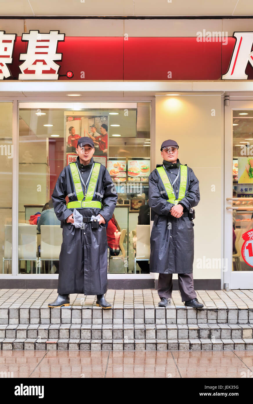 Security guards in front of KFC outlet. Concern over deadly arson attacks is prompting wider use of security guards in Chinese urban areas. Stock Photo