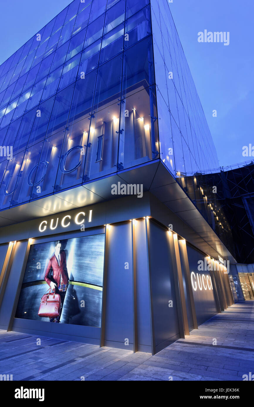 Gucci store at twilight. Chinese luxury goods market account for 28% of global sales for Swatch, 22%, 18% for Gucci, 14% for Bulgari, 11% for Hermes. Stock Photo