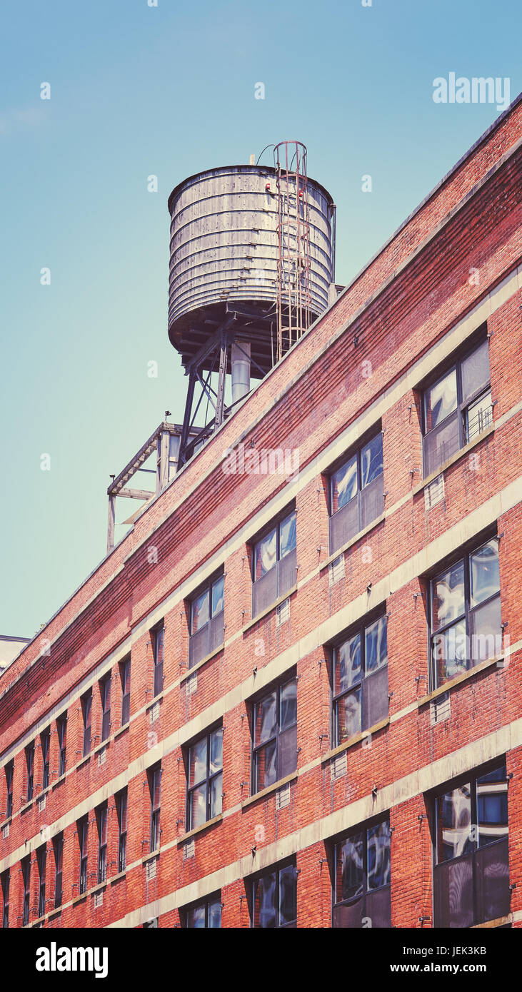 Vintage toned picture of a rooftop water tank on a New York city apartment building, USA. Stock Photo