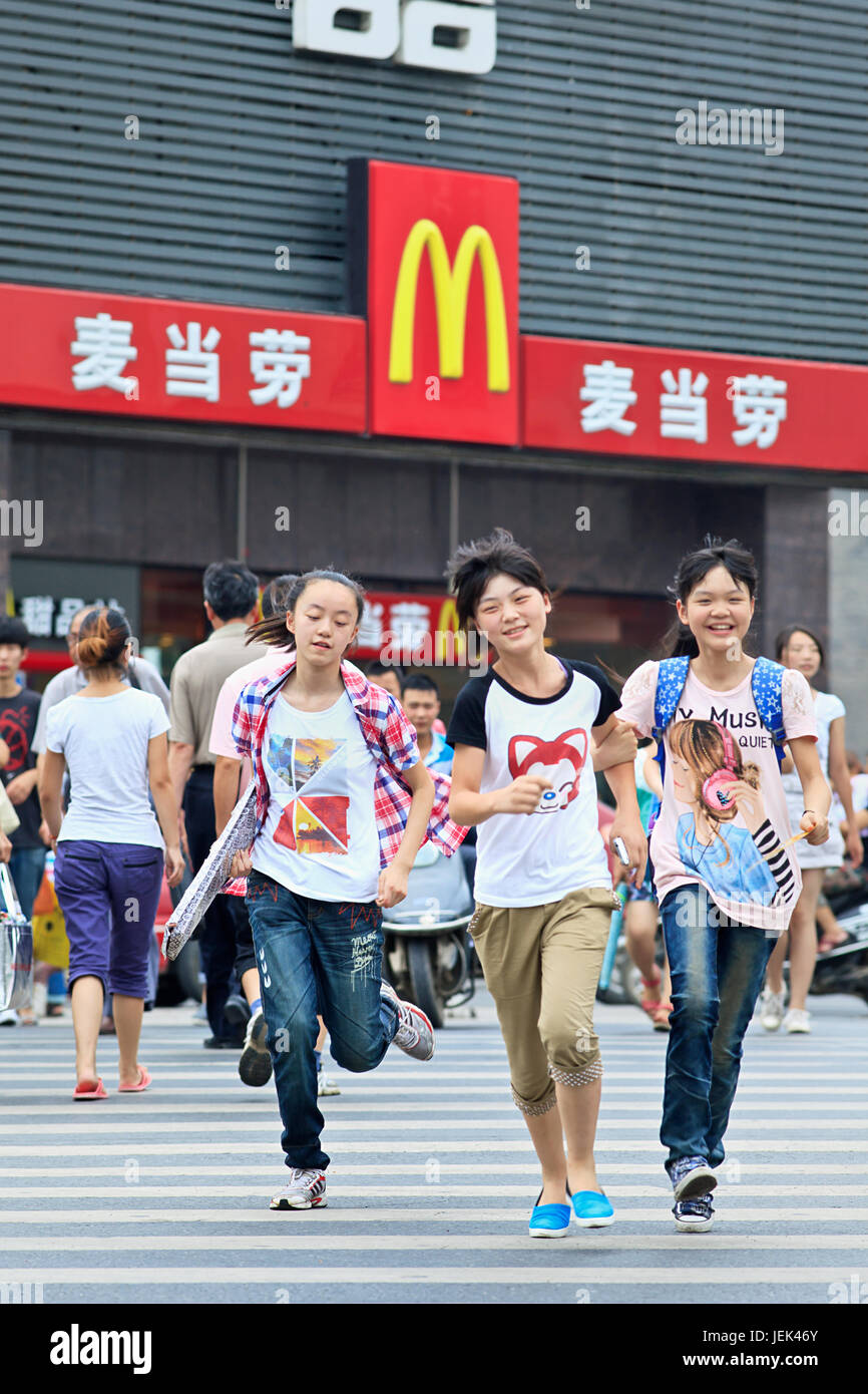 XIANG YANG-CHINA-JULY 3, 2012. Teenagers in front of McDonald's. It took McDonald's 19 years to reach 1,000 restaurants all over China. Stock Photo