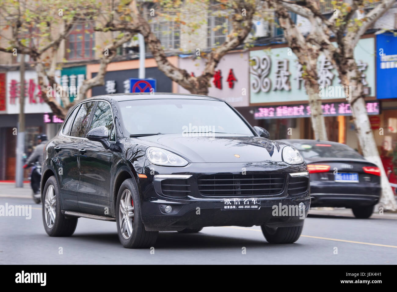 Black Porsche Cayenne. Since 2010, Porsche has tripled China sales. But After government crackdown on conspicuous consumption, luxury market slows. Stock Photo