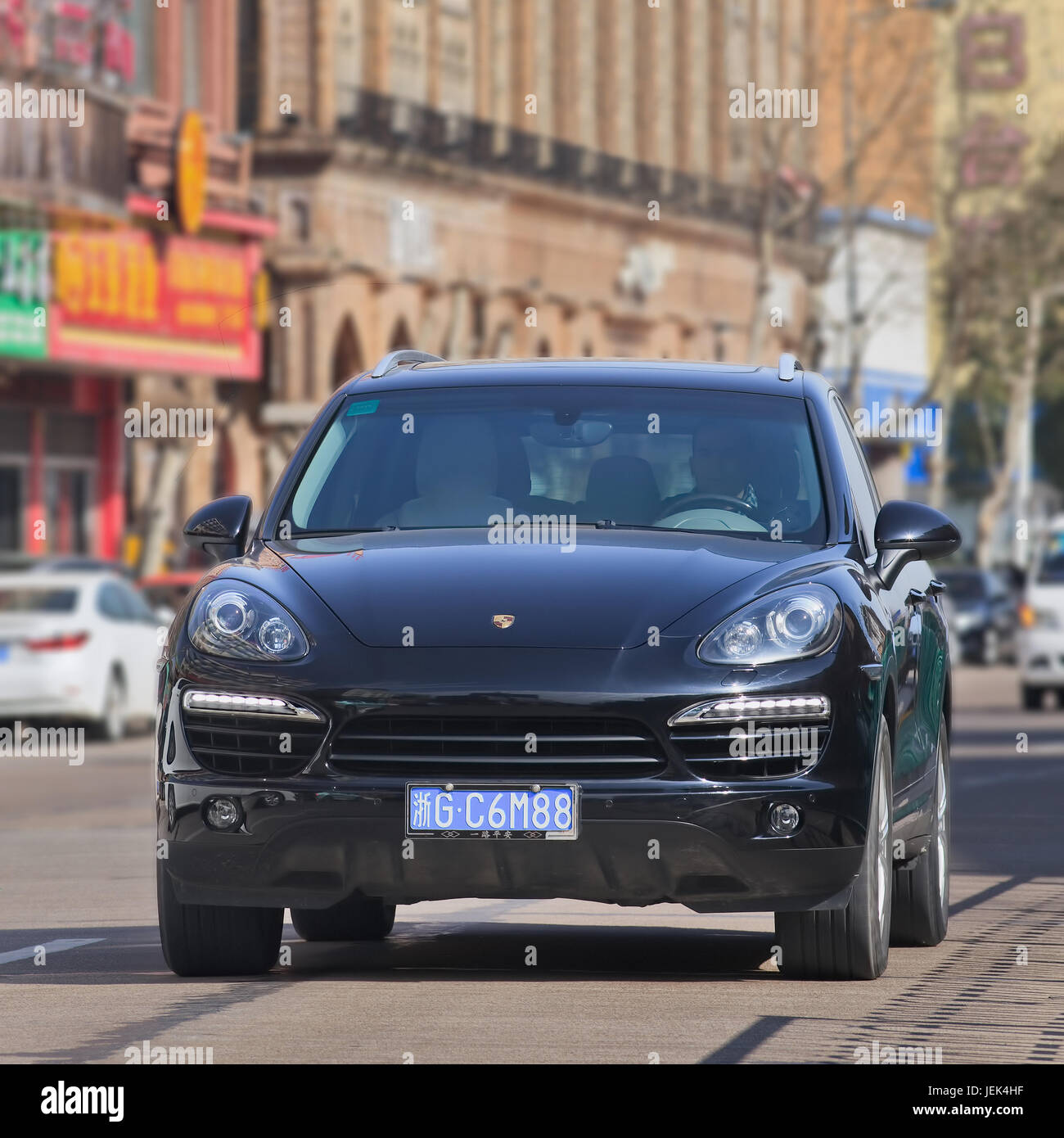 Black Porsche Cayenne. Since 2010, Porsche has tripled China sales. But After government crackdown on conspicuous consumption, luxury market is slows. Stock Photo