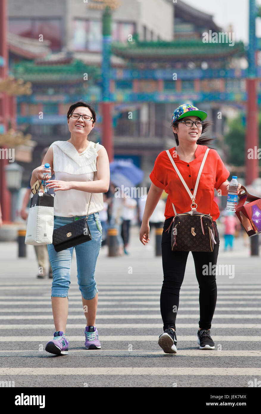 Two Chinese ladies carry Louis Vuitton handbags at Beijing Scitech Premium  Outlet Mall in Beijing, China. 15-May-2010 Stock Photo - Alamy