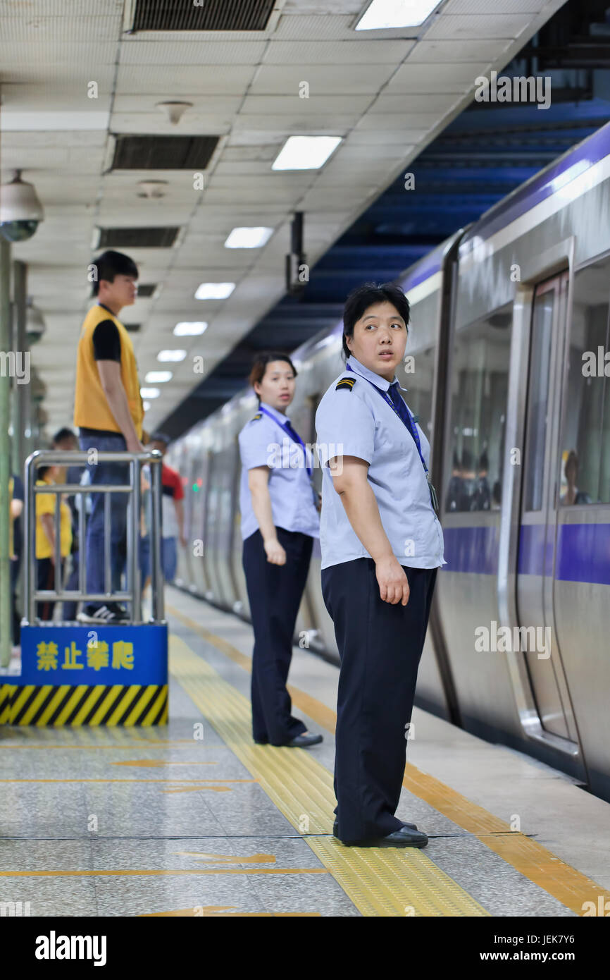 BEIJING-JUNE 9, 2015. Personnel in subway station. Subway rail network serves Beijing urban and suburban districts with 18 lines, 319 stations, 527 KM. Stock Photo