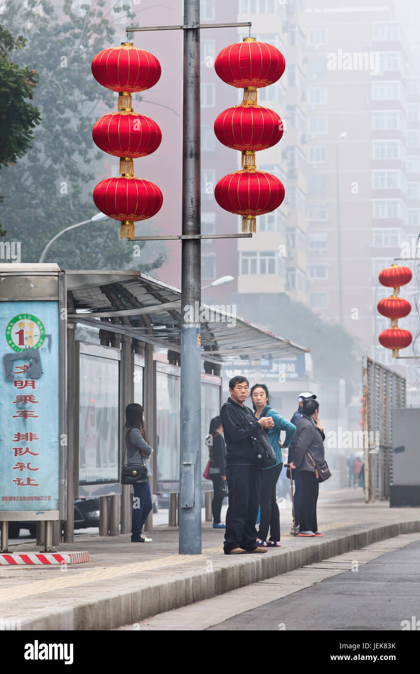 BEIJING-OCT. 11 ,2014. People at bus station in smog blanketed city. Beijing was draped in severe smog for a week. Stock Photo