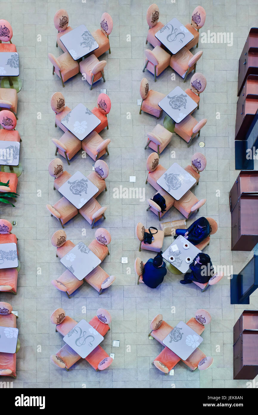 BEIJING-FEBR. 21. People in coffee shop at Beijing Capital Airport. The world’s largest airport terminal measures 986,000 m2 floor surface. Stock Photo
