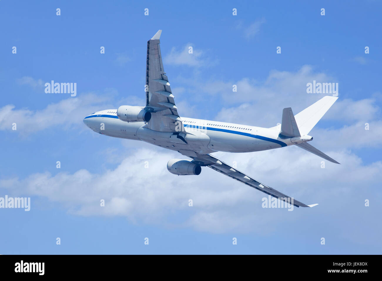Twin-engine airliner climbing upwards. Stock Photo