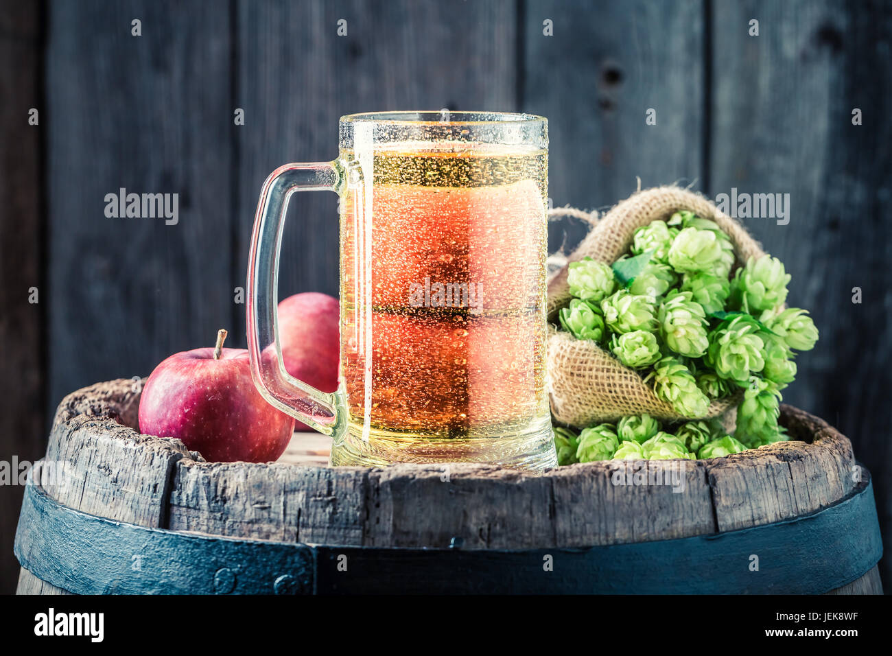 Closeup of cider beer with apples, hops and wheat Stock Photo