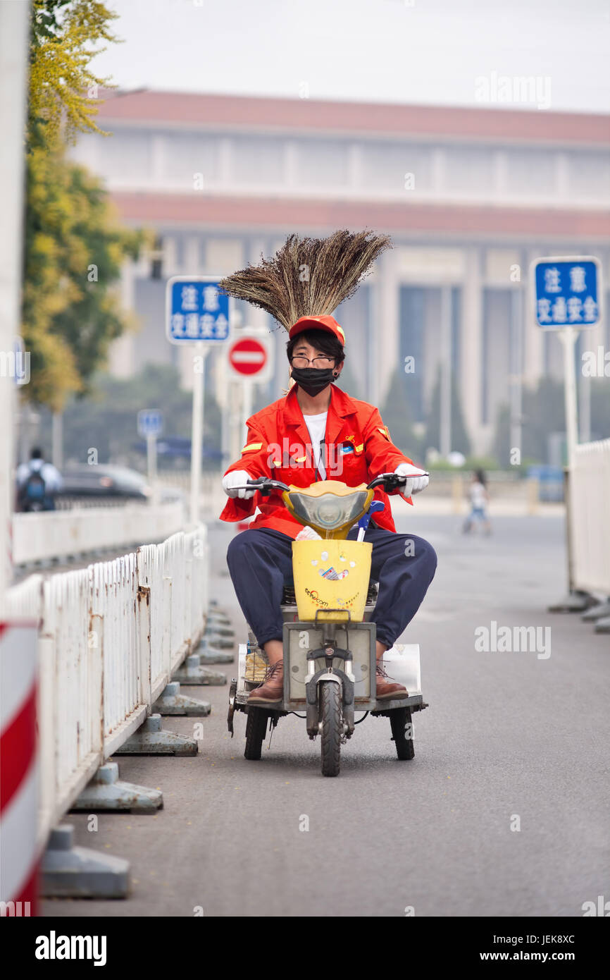 BEIJING-JUNE 1, 2015. Funny street sweeper on electric trike. Thanks to army of street sweepers Beijing center around Tiananmen Square is very clean. Stock Photo