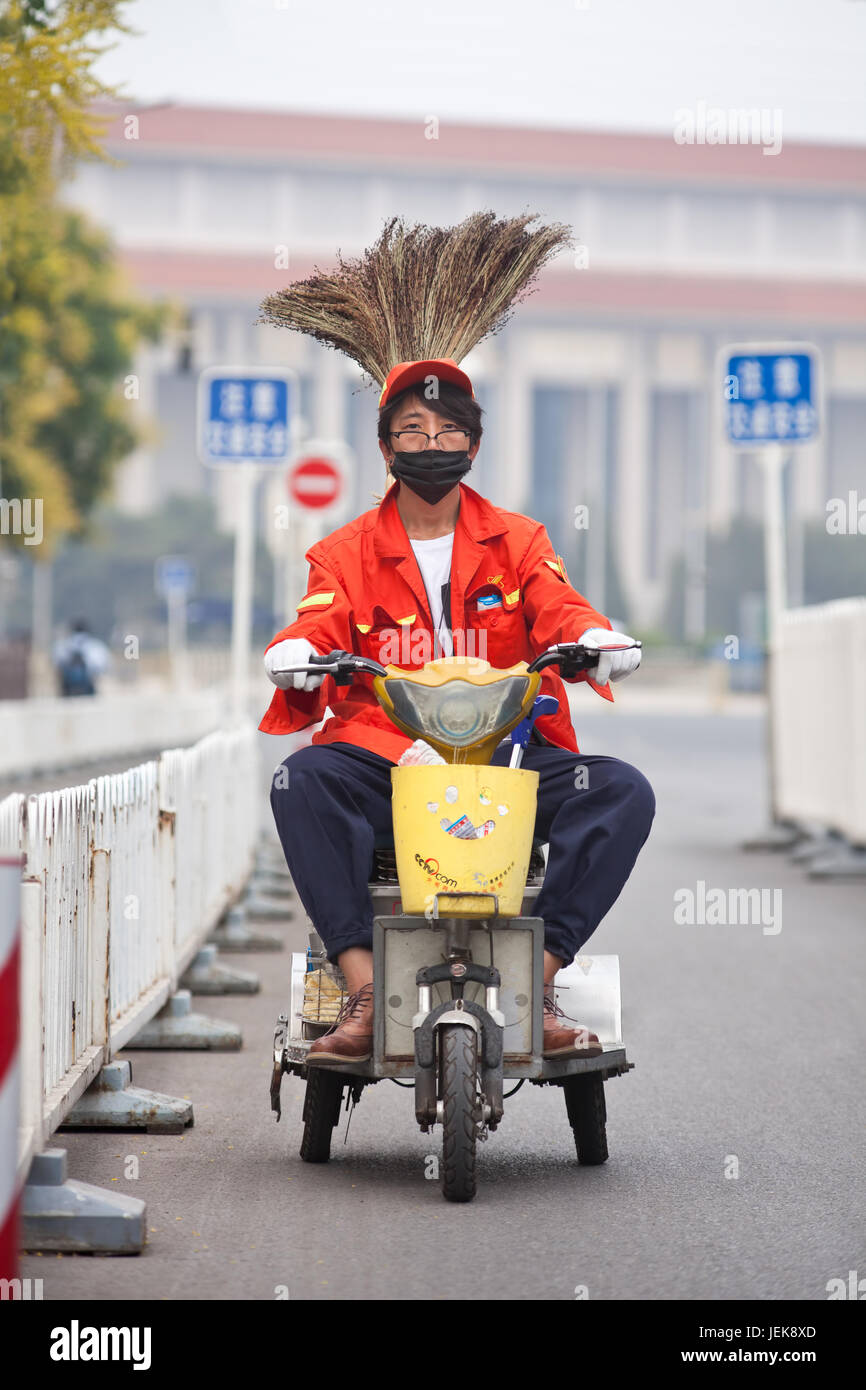 BEIJING-JUNE 1, 2015. Funny street sweeper on electric trike. Thanks to army of street sweepers Beijing center around Tiananmen Square is very clean. Stock Photo