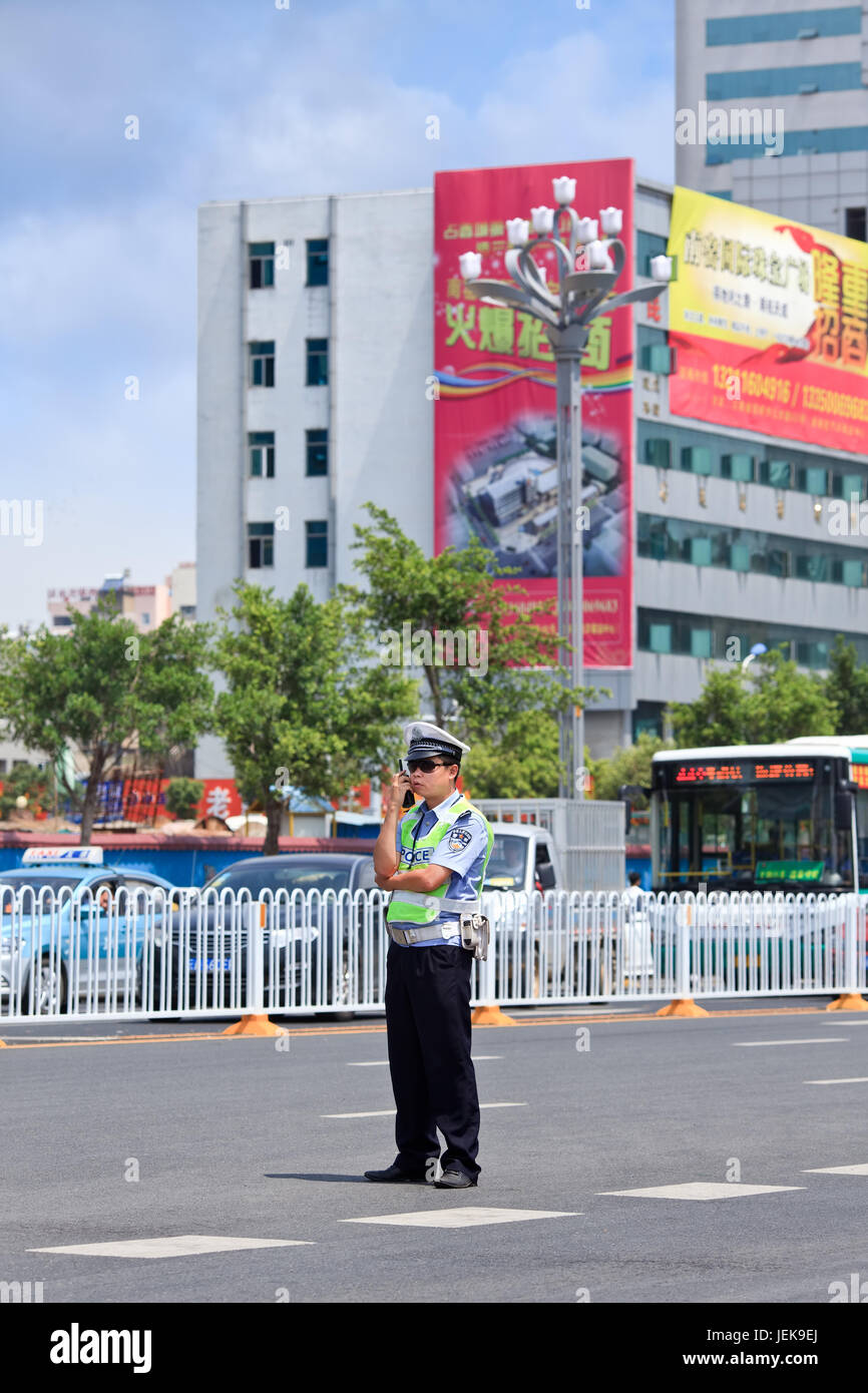 KUNMING-JULY 5, 2014. Police officer in an urban scene with traffic jam on background. Stock Photo