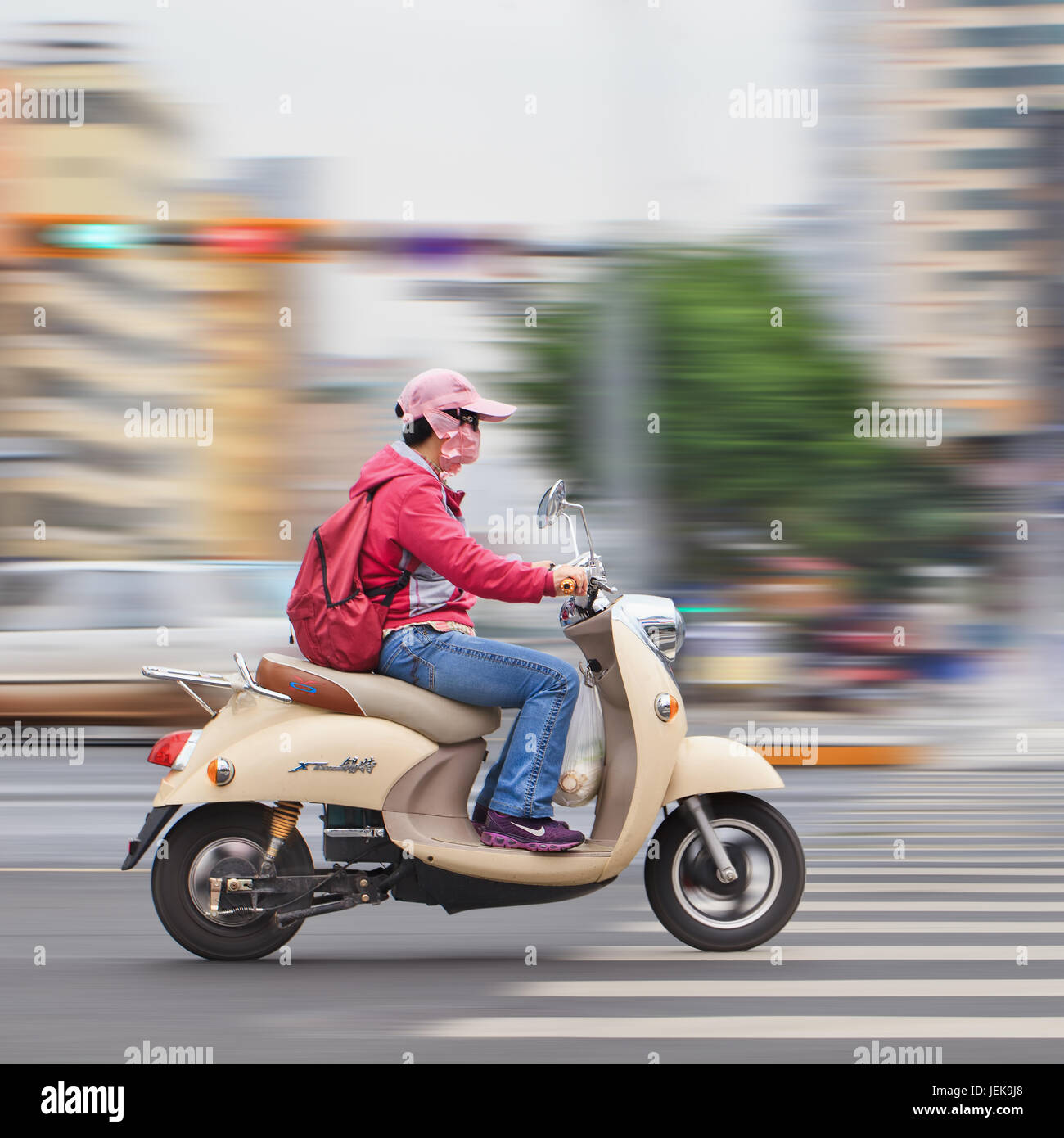 KUNMING-JULY 5, 2014. Retro design e-bike on the road. Although US politicians doing little to encourage their use, the number of electric-powered bic Stock Photo
