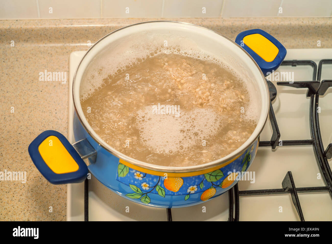 Cooking pearl barley in pot on gas stove Stock Photo Alamy