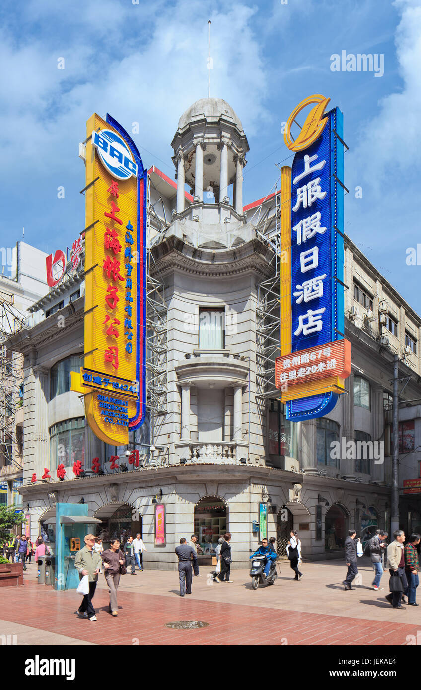 SHANGHAI-MAY 5, 2014. Art Deco building with large neon structures in Nanjing East Road. Shanghai’s art deco heritage is unsurpassed in Asia. Stock Photo