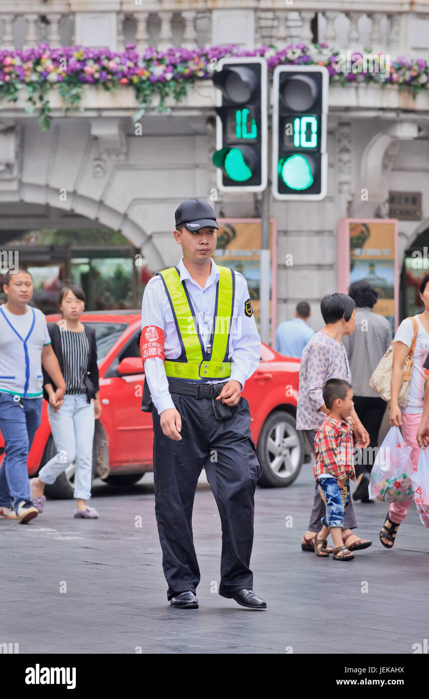 Security Guard walks in city center. Shanghai ranks as safest city in China, according to recent survey jointly conducted by Insight China. Stock Photo