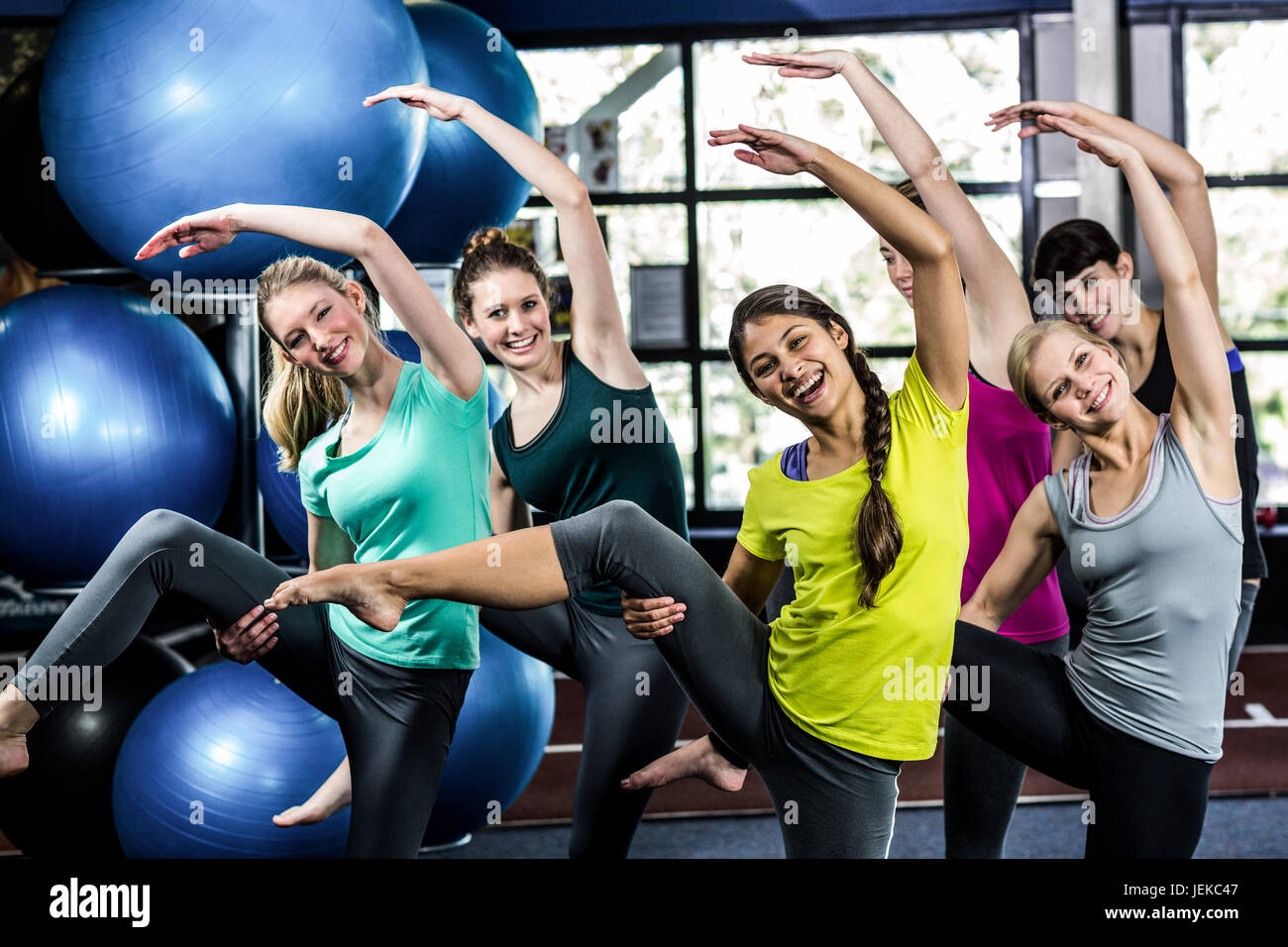 Jekc Fit smiling group doing stretching Stock Photo - Alamy
